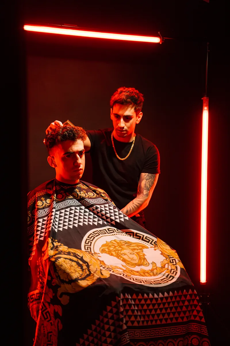 Barber at work under red light