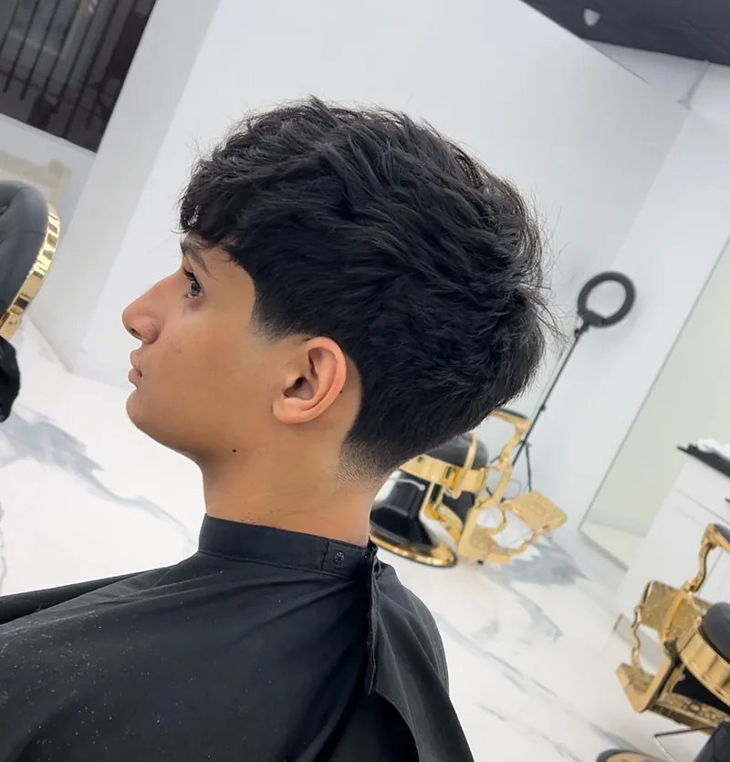 Curly fringe with a taper